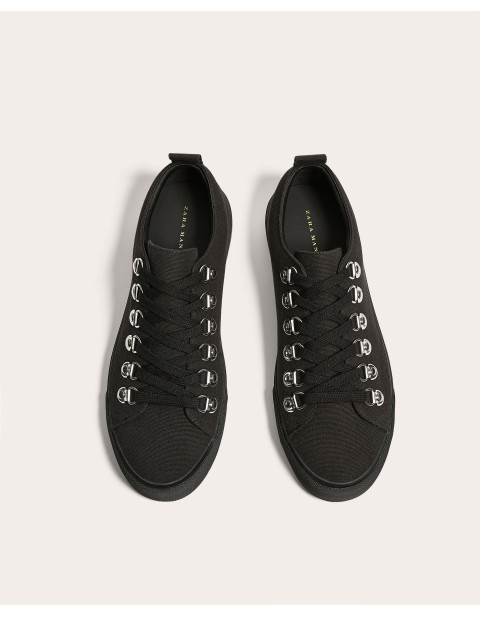 BLACK PLIMSOLLS WITH EYELETS DETAIL